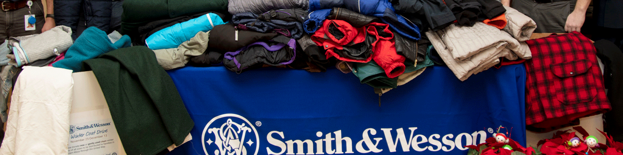 pile of donated winter coats from Smith and Wesson employees