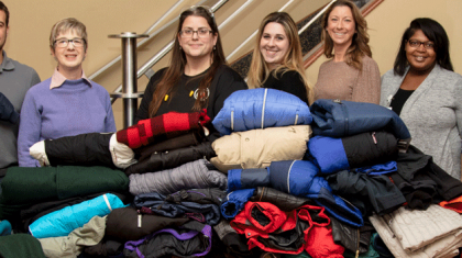 pile of donated winter coats from Smith and Wesson employees